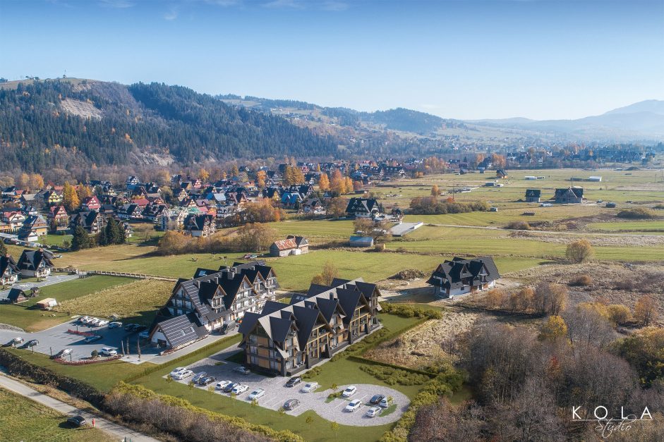 Wizualizacja z lotu ptaka pokazująca duży kompleks hotelowy zaprojektowany w tradycyjnym góralskim stylu, położony na Podhalu